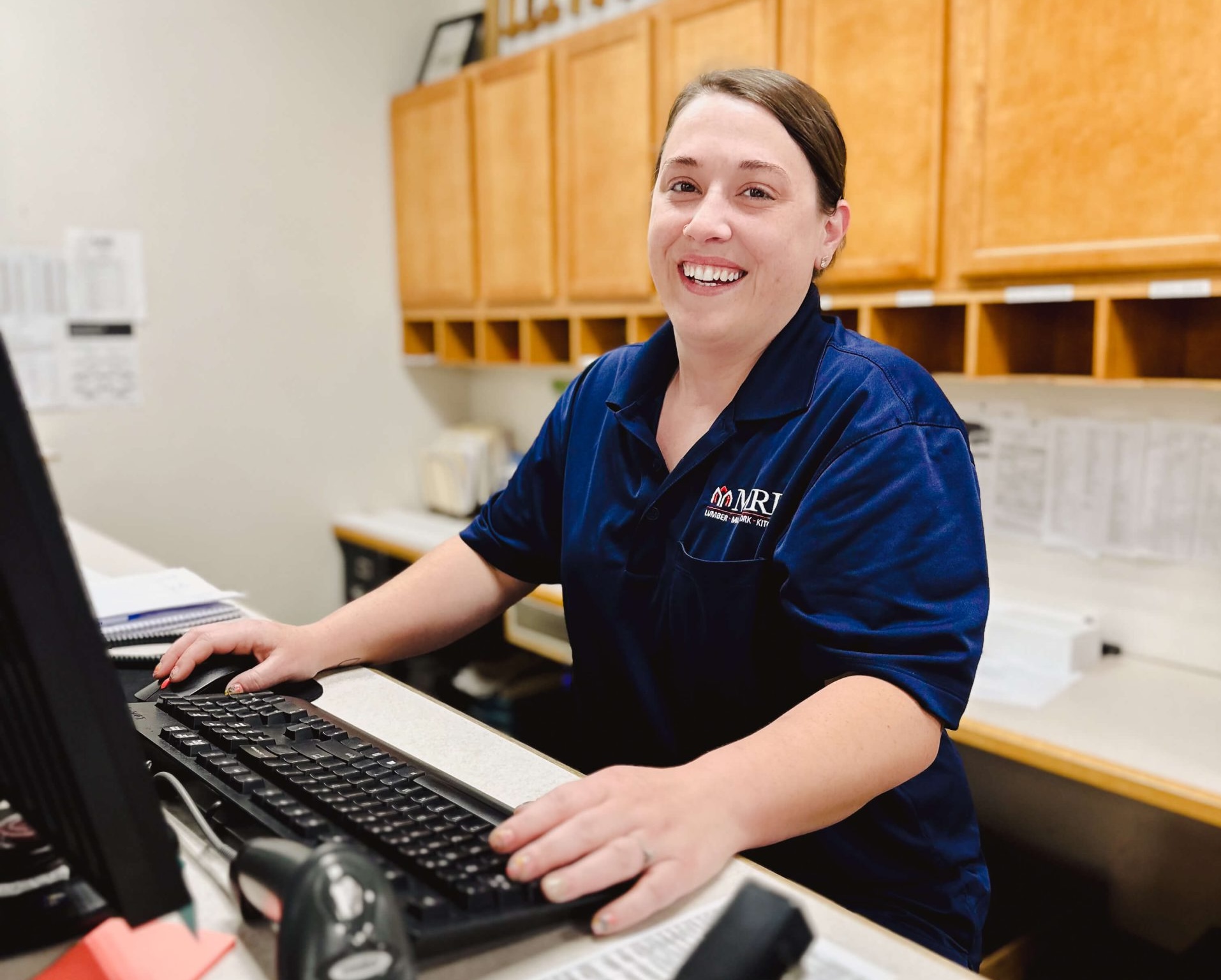 A proud MRD team member hard at work in the office.