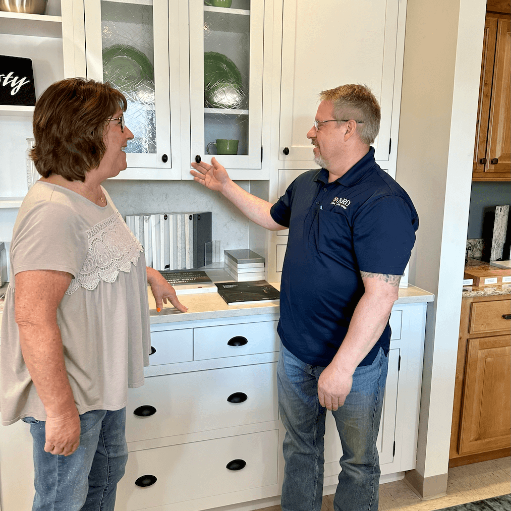 An MRD employee going over cabinet options with a customer in the showroom.